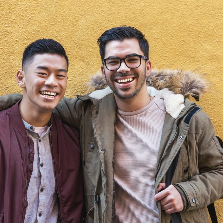 Portrait of group of friends looking the camera in the street.